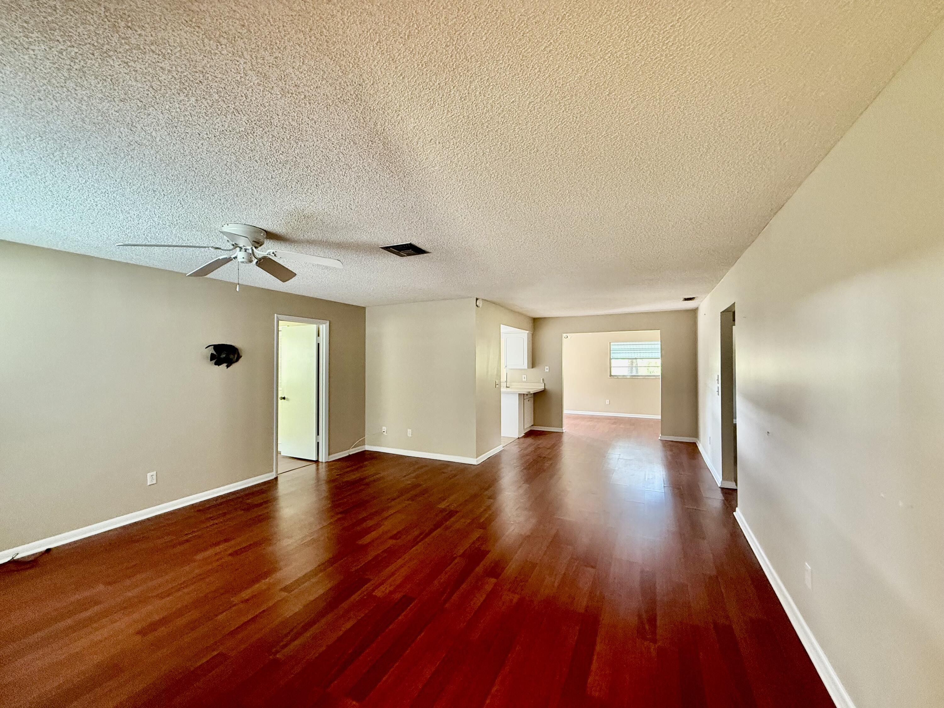 612 Coconut Avenue North Port St. Lucie, FL 34952 - Photo 29 of 32 a view of an empty room with wooden floor and a window