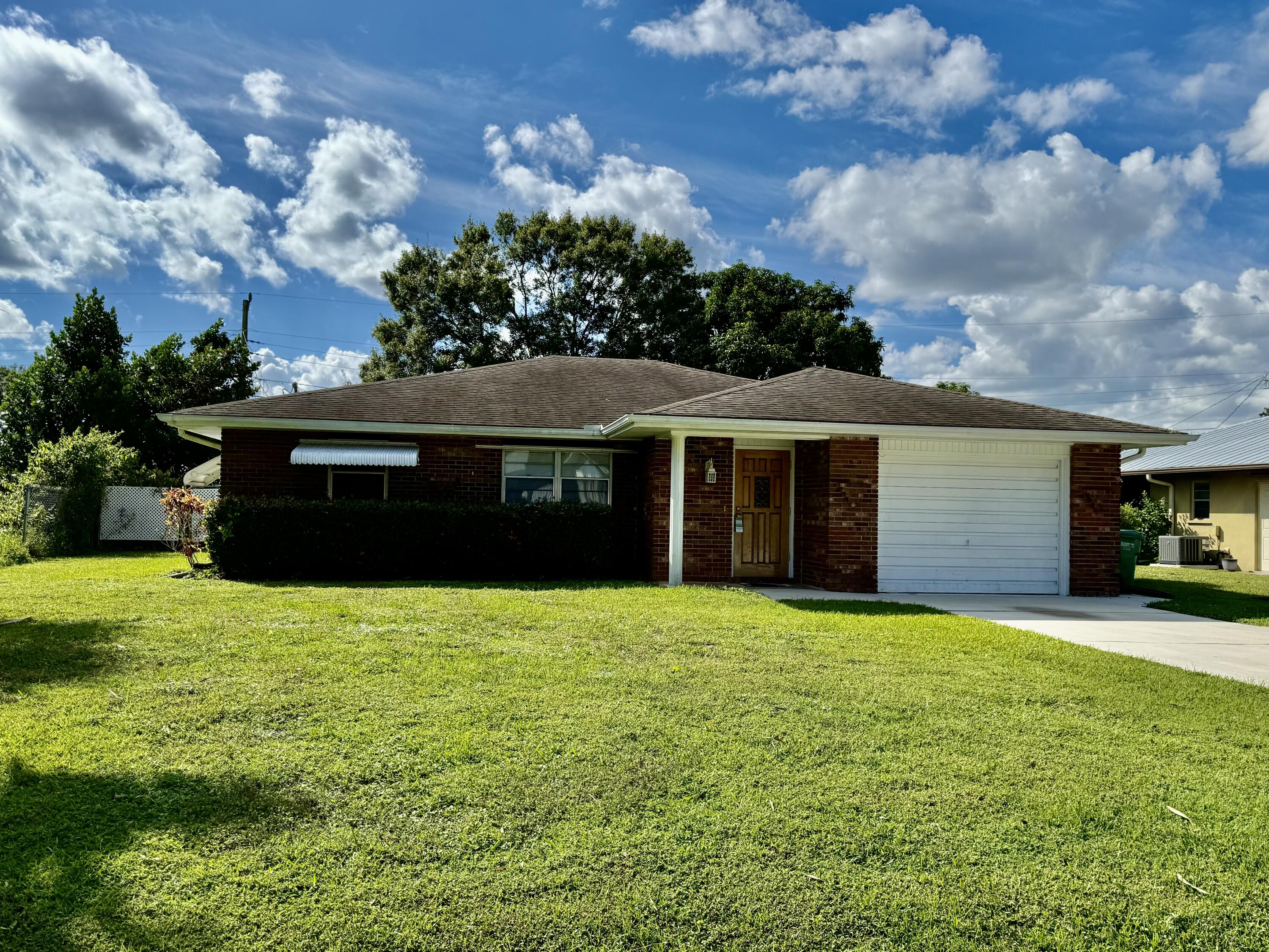 612 Coconut Avenue North Port St. Lucie, FL 34952 - Photo 30 of 32 a view of house with yard and entertaining space