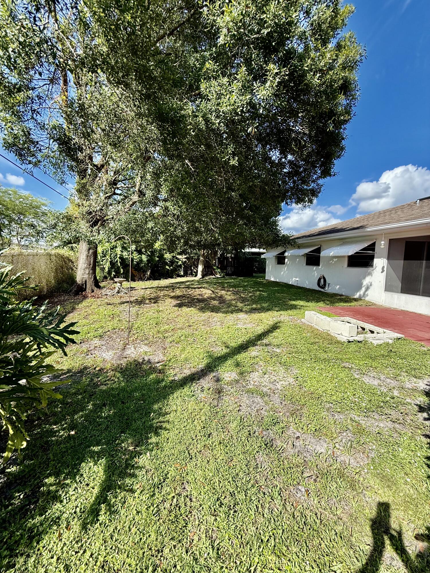 612 Coconut Avenue North Port St. Lucie, FL 34952 - Photo 8 of 32 a swimming pool with outdoor seating and yard