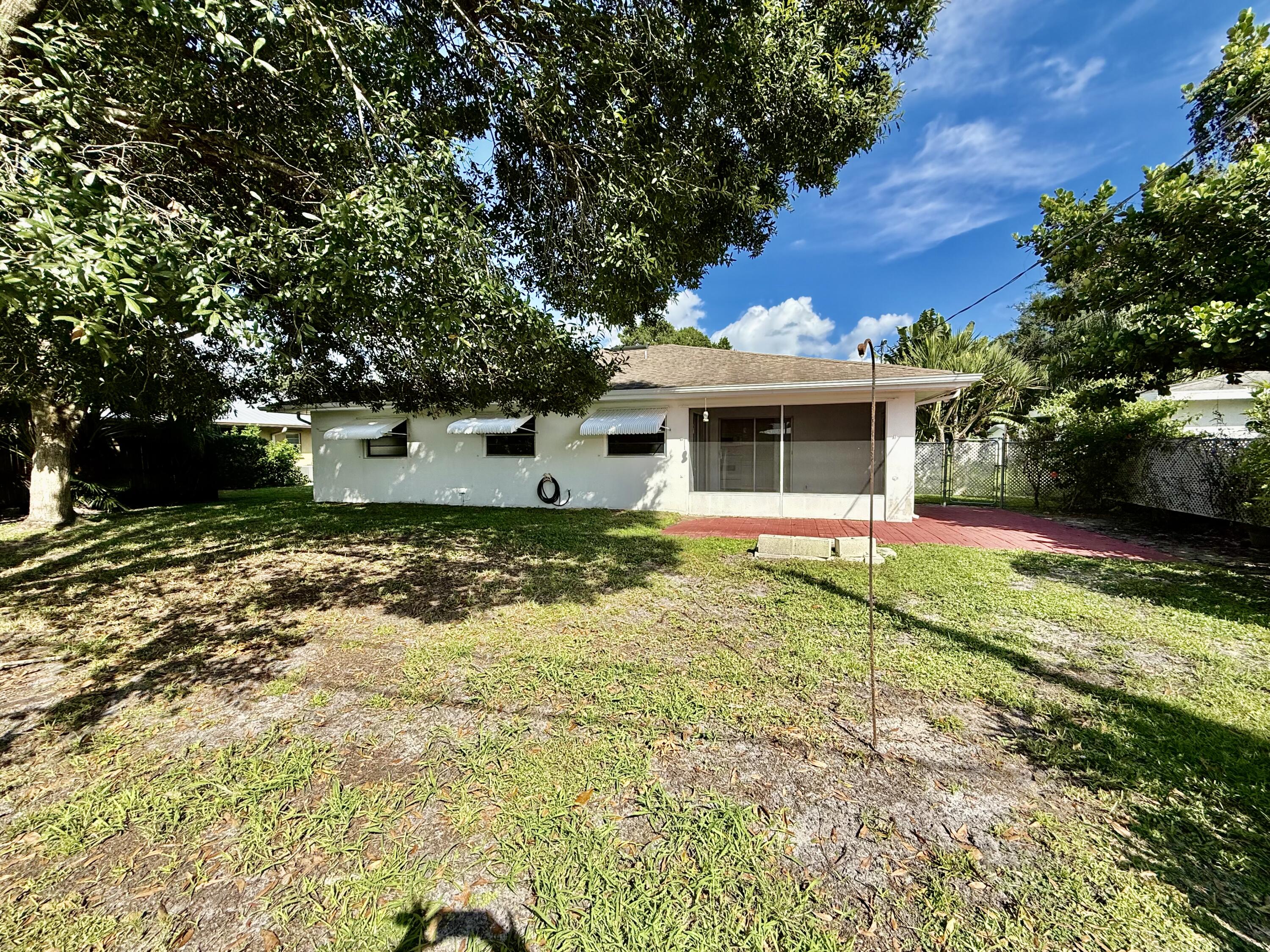 612 Coconut Avenue North Port St. Lucie, FL 34952 - Photo 10 of 32 a view of a house with a yard