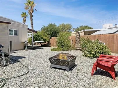 a wooden bench sitting in backside of a house