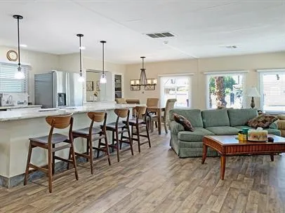 a living room with lots of furniture and kitchen view