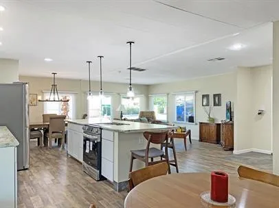 a view of a dining room with furniture window and wooden floor