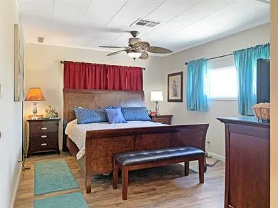 a bedroom with a bed and wooden furniture