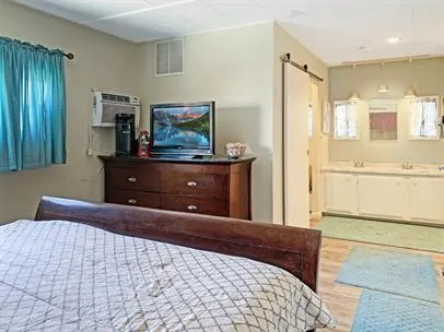 a bedroom with a bed and a dresser