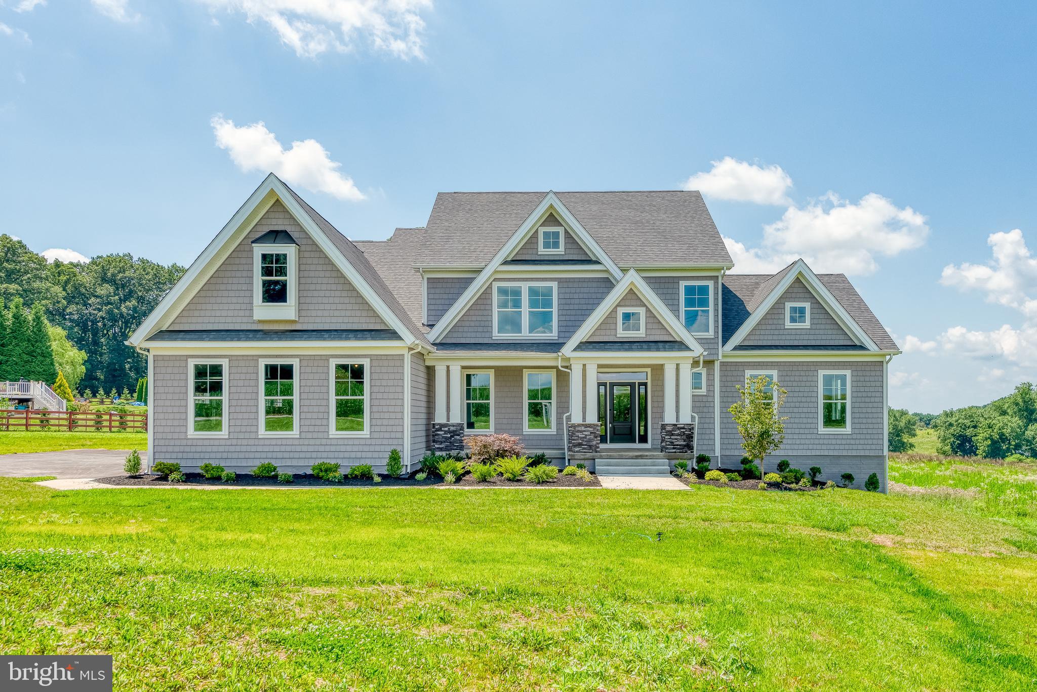 1605 Oakland Road Freeland, MD 21053 - Photo 1 of 57 a front view of a house with a yard and potted plants