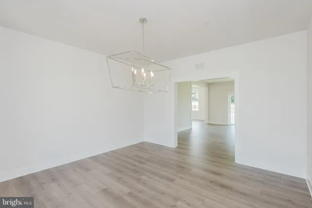 a large kitchen with kitchen island a sink stainless steel appliances and cabinets