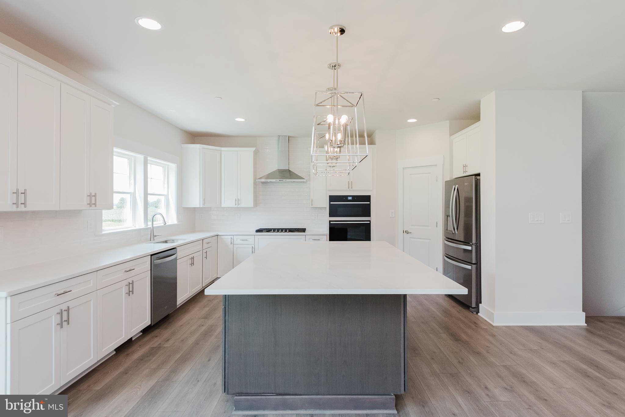 1605 Oakland Road Freeland, MD 21053 - Photo 16 of 57 a large kitchen with kitchen island a sink stainless steel appliances and cabinets