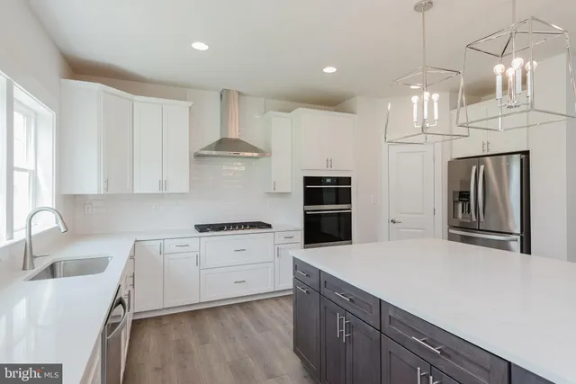 a kitchen with stainless steel appliances a white stove top oven sink and window