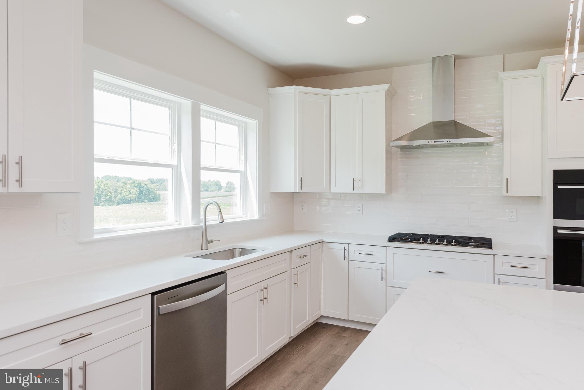 1605 Oakland Road Freeland, MD 21053 - Photo 19 of 57 a kitchen with stainless steel appliances a white stove top oven sink and window