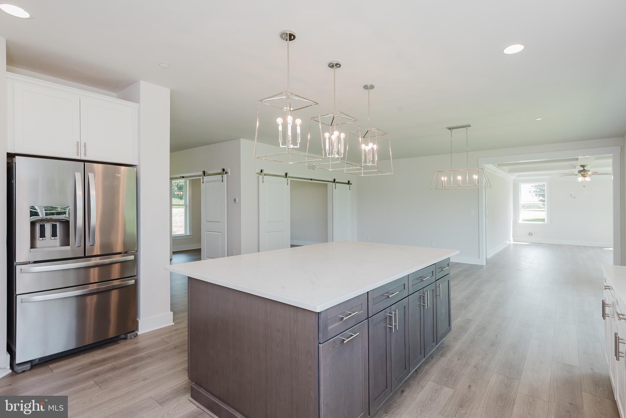 1605 Oakland Road Freeland, MD 21053 - Photo 21 of 57 a kitchen with kitchen island a counter top space wooden floor and stainless steel appliances