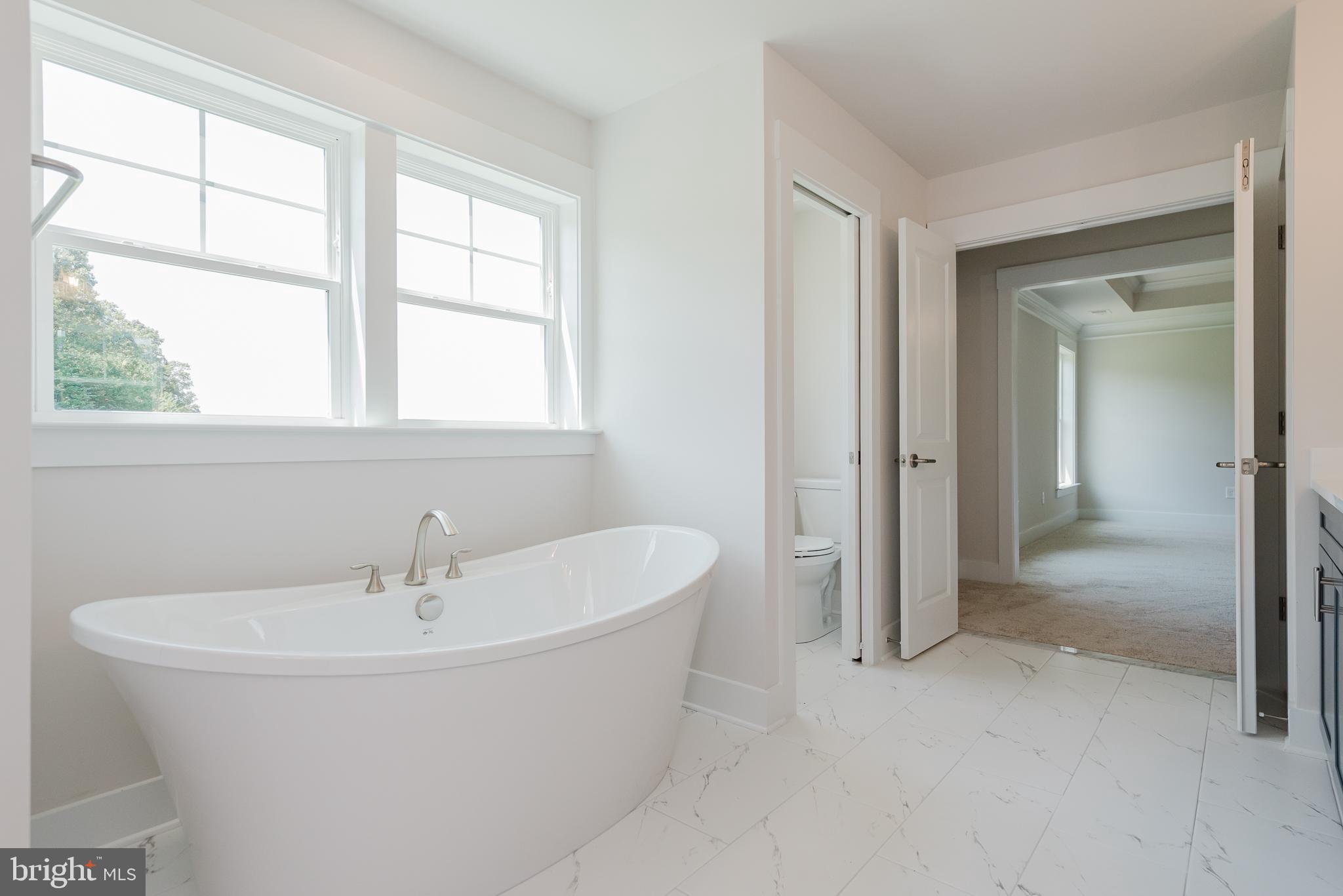 1605 Oakland Road Freeland, MD 21053 - Photo 32 of 57 a bathroom with a white tub shower and sink