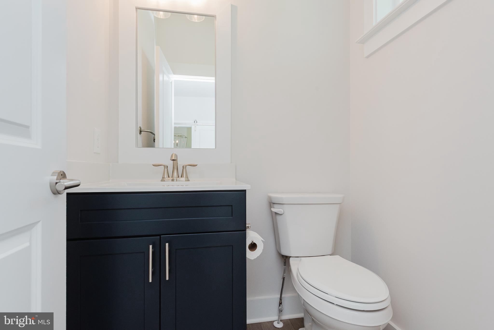 1605 Oakland Road Freeland, MD 21053 - Photo 40 of 57 a bathroom with a toilet a sink and mirror