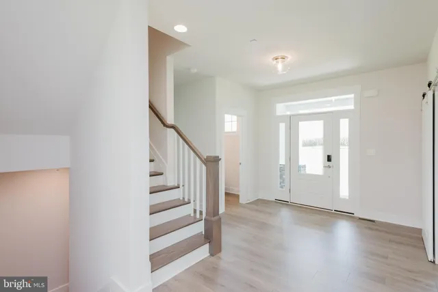 a view of a hallway view with wooden floor and staircase