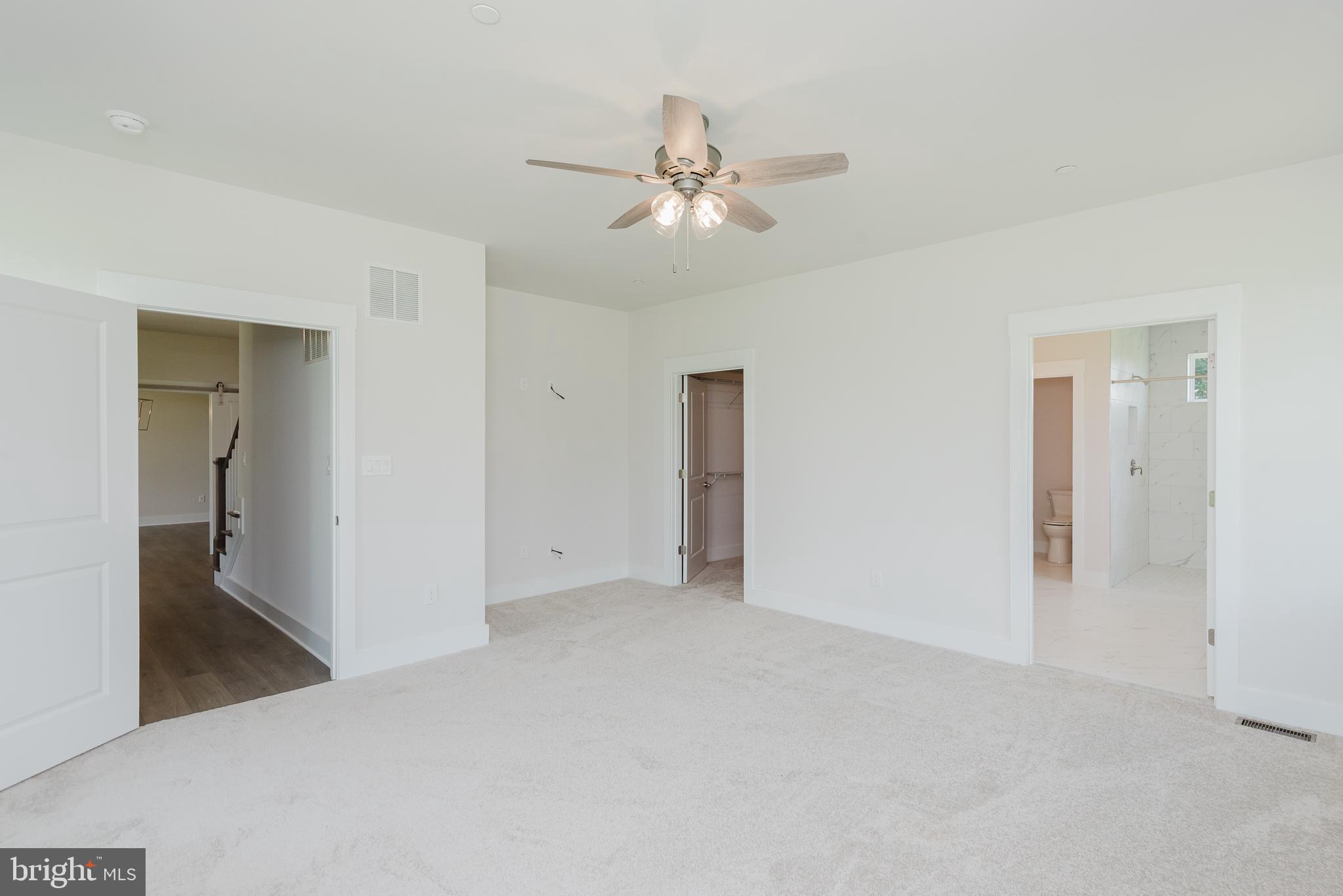 1605 Oakland Road Freeland, MD 21053 - Photo 8 of 57 an empty room with fan and hallway