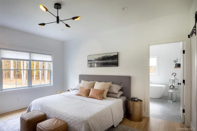 a bedroom with a large bed and a window