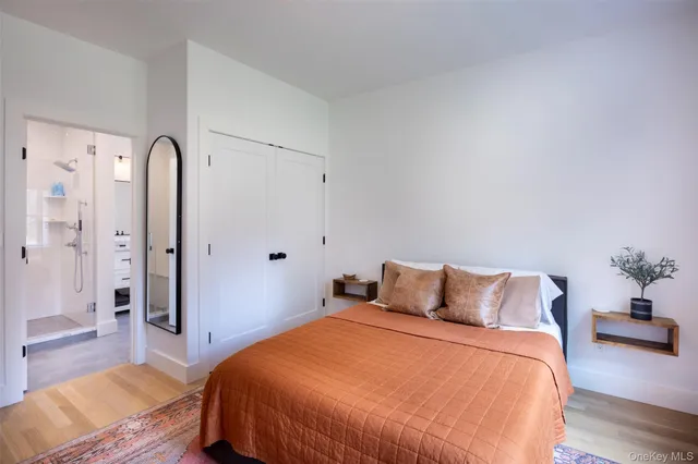 a bedroom with bed and wooden floor