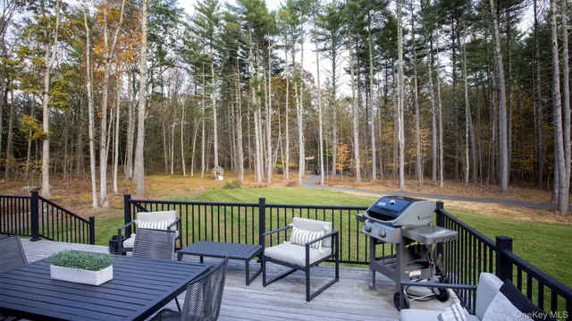 a view of a chairs and table in patio with wooden fence