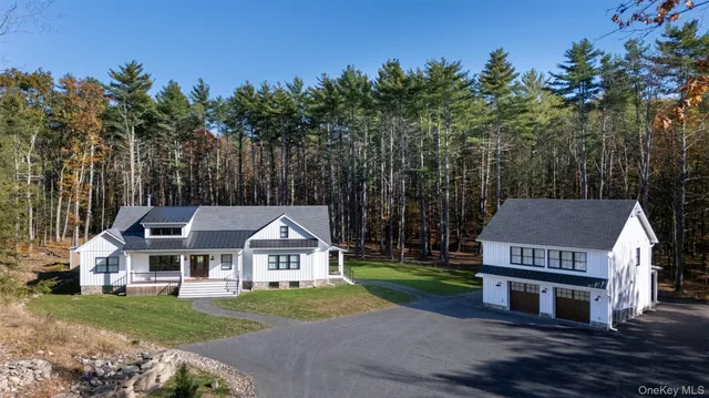 a front view of a house with a garden and yard