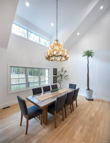 a dining room with furniture a rug and a chandelier
