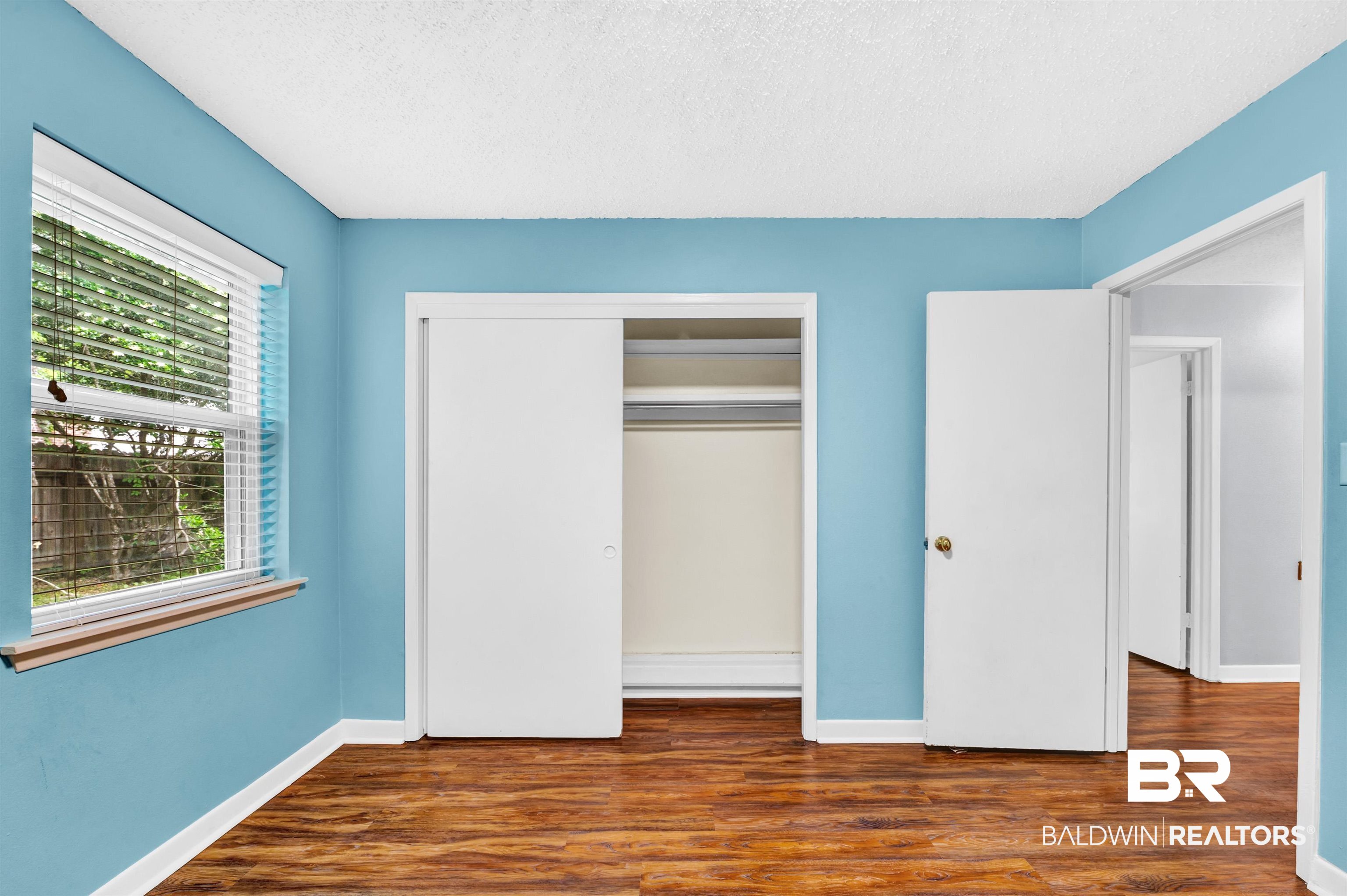 28 Caisson Trace Spanish Fort, AL 36527 - Photo 31 of 51 Unfurnished bedroom featuring baseboards, wood finished floors, and a closet