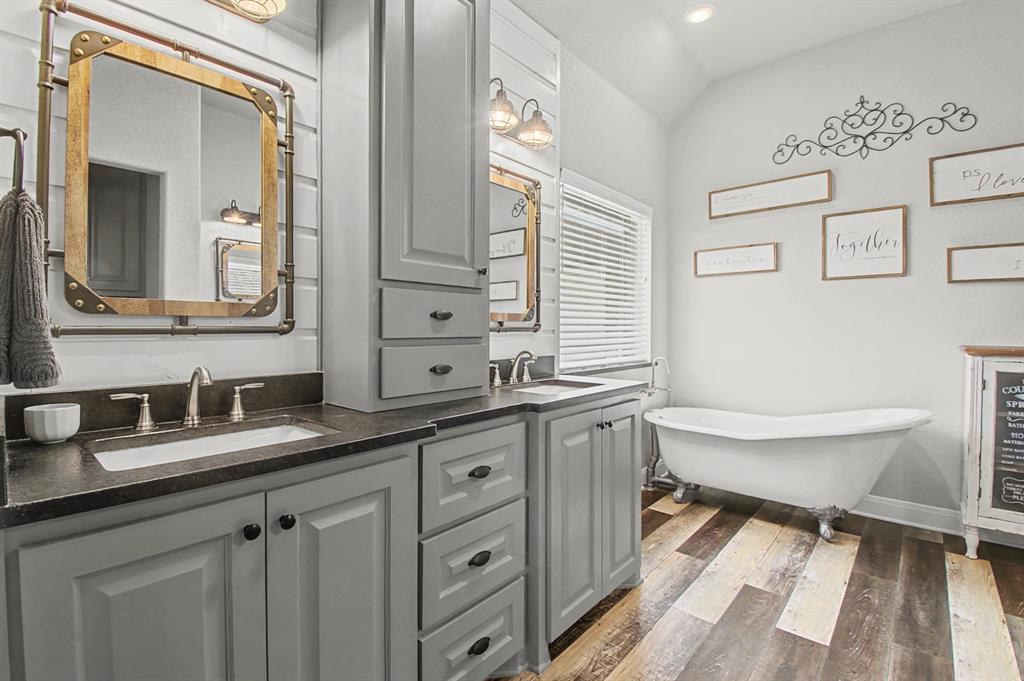793 County Road 2535 Decatur, TX 76234 - Photo 21 of 39 a bathroom with a granite countertop sink mirror and a bathtub