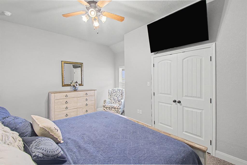 793 County Road 2535 Decatur, TX 76234 - Photo 25 of 39 a bedroom with a bed and a flat screen tv