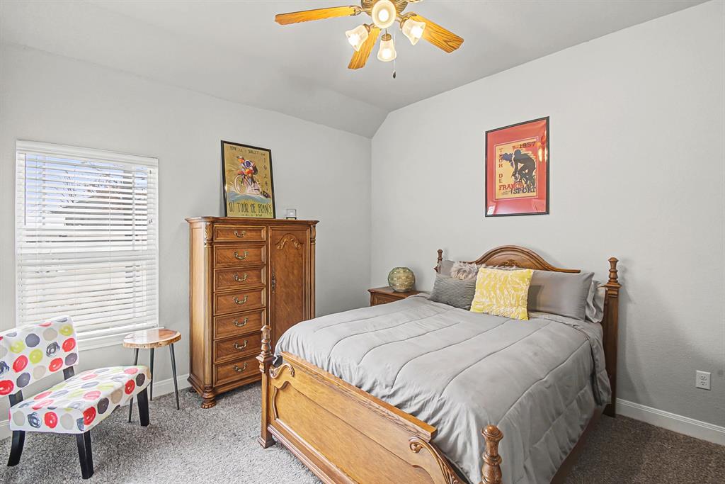 793 County Road 2535 Decatur, TX 76234 - Photo 27 of 39 a bedroom with a bed and a chandelier