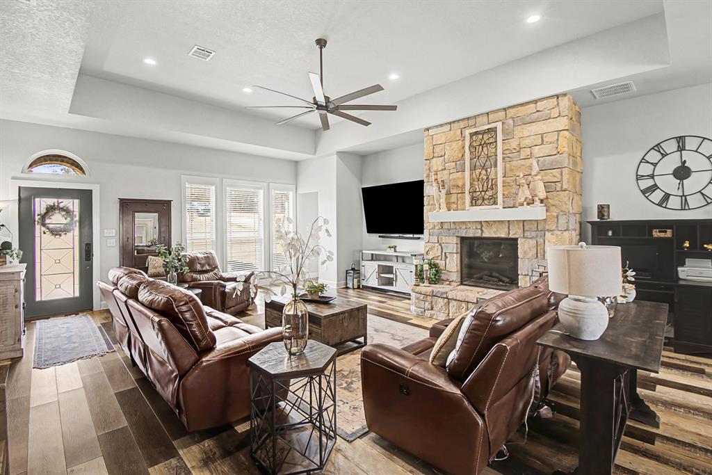 793 County Road 2535 Decatur, TX 76234 - Photo 8 of 39 a living room with furniture a fireplace and a flat screen tv