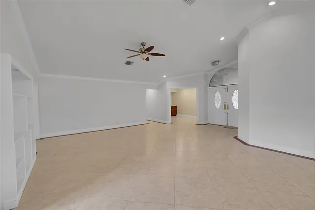 an empty room with a empty space and windows