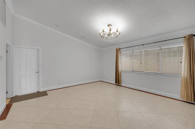 a large bedroom with kitchen island granite countertop a stove a sink and a refrigerator