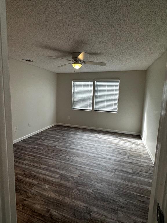 124 Loblolly Court, Unit F Oldsmar, FL 34677 - Photo 14 of 33 an empty room with wooden floor and windows