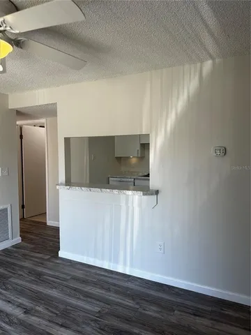 a kitchen with granite countertop a sink and a stove top oven