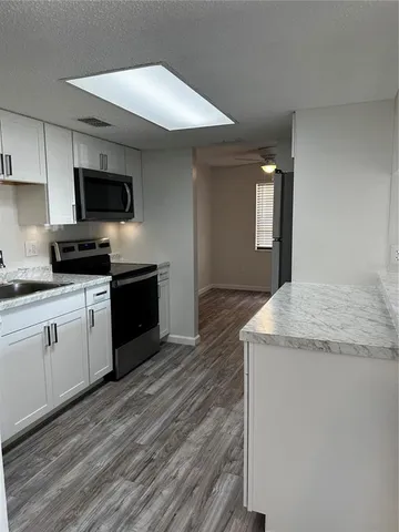 a view of hallway with wooden floor