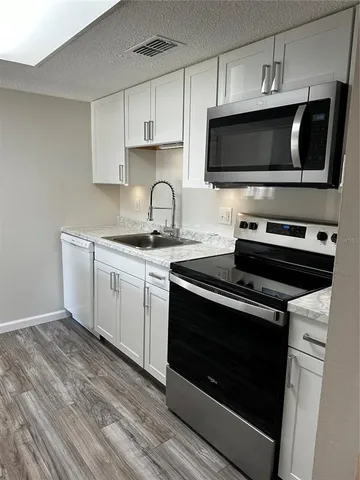 a white refrigerator freezer sitting in a kitchen