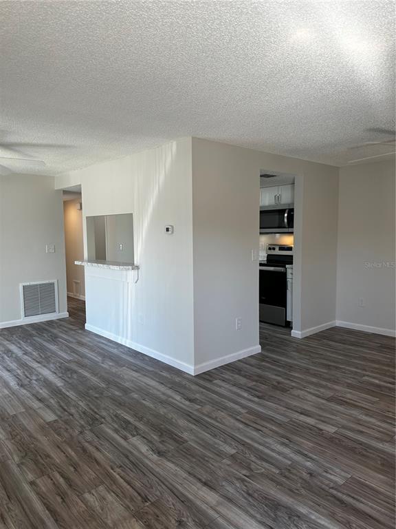 124 Loblolly Court, Unit F Oldsmar, FL 34677 - Photo 27 of 33 a view of empty room with wooden floor