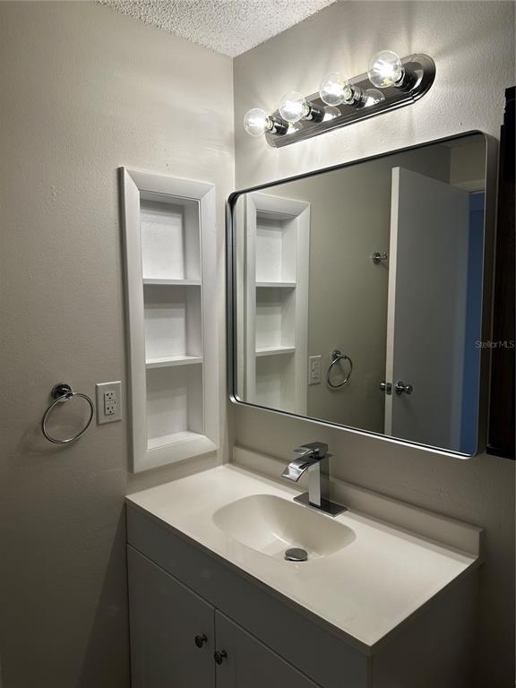 124 Loblolly Court, Unit F Oldsmar, FL 34677 - Photo 8 of 33 a bathroom with a sink and a mirror