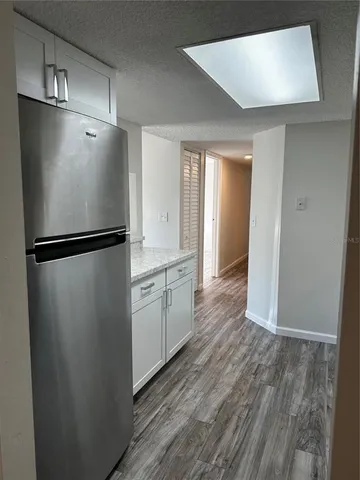 a view of granite countertop cabinets and window