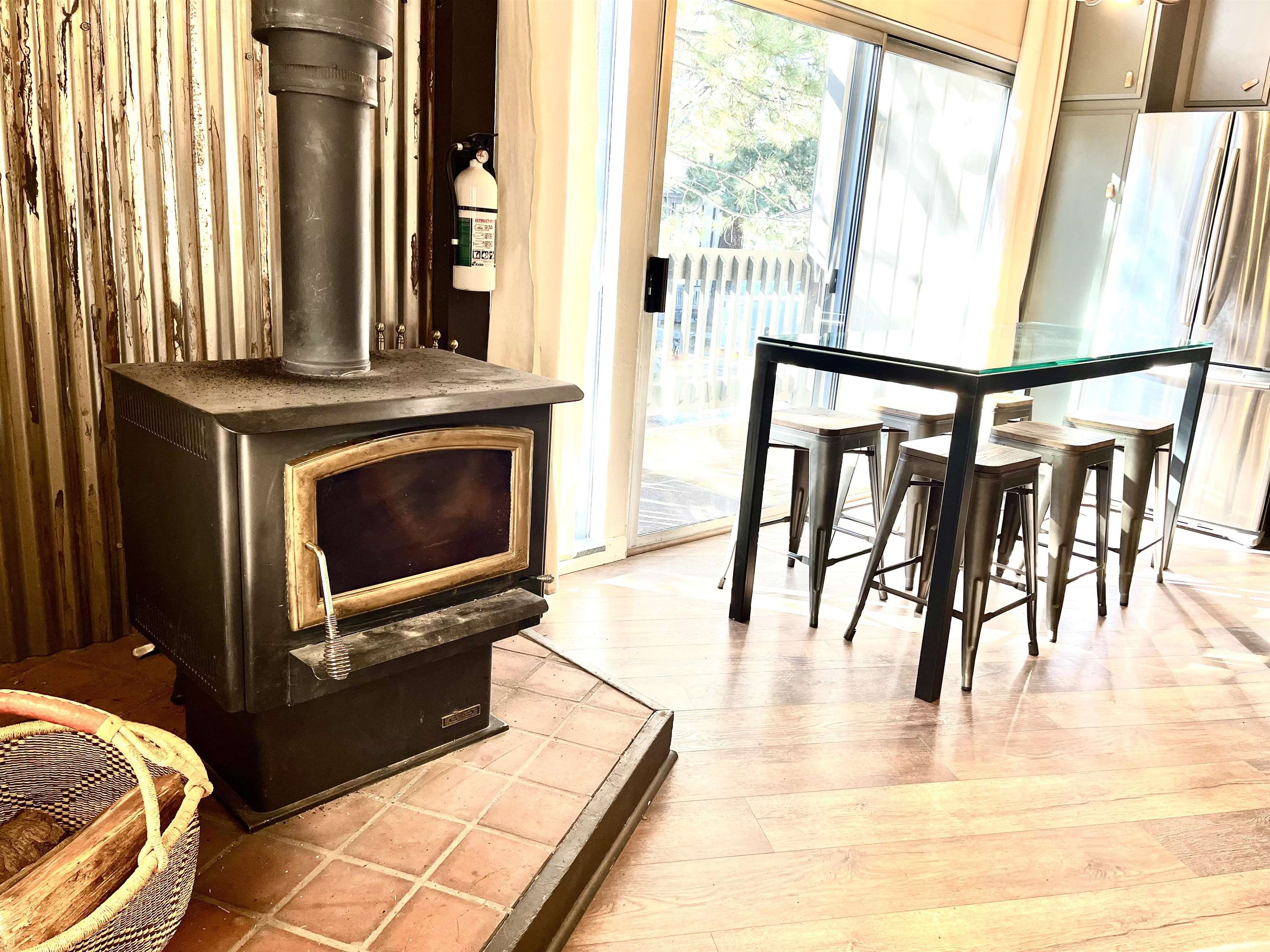 286 Old Mammoth Road, Unit 7 Mammoth Lakes, CA 93546 - Photo 8 of 32 Dining space featuring a wood stove and light wood-style flooring