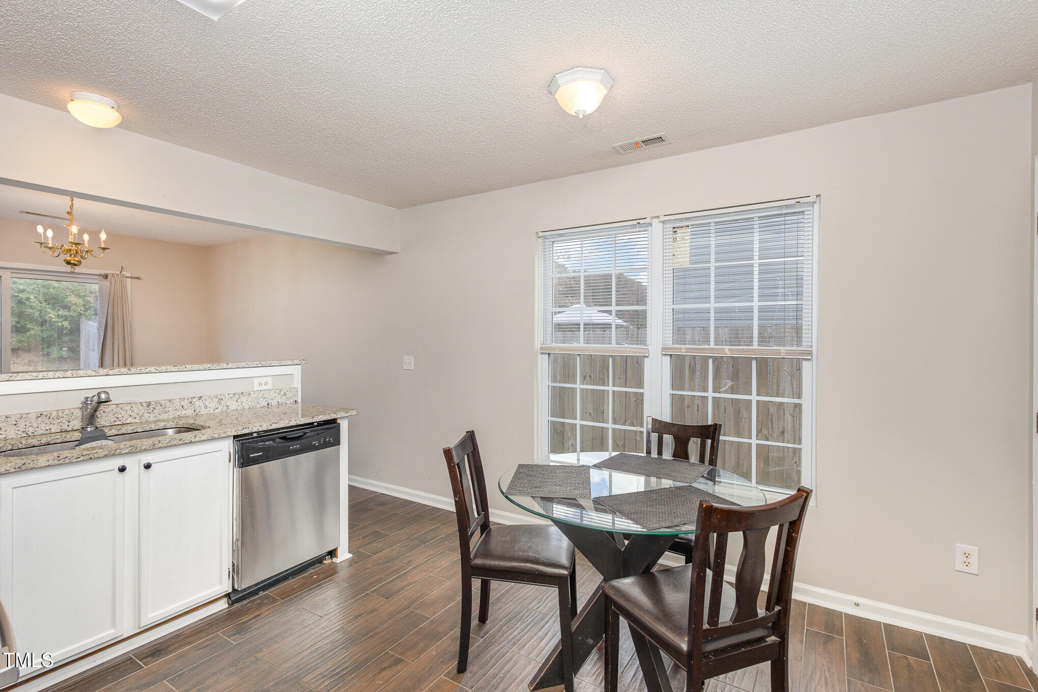 4331 Crowfield Drive Raleigh, NC 27610 - Photo 12 of 26 a view of a dining room with furniture and wooden floor