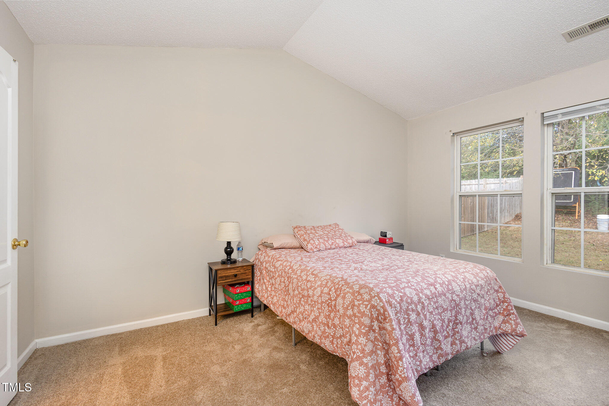 4331 Crowfield Drive Raleigh, NC 27610 - Photo 15 of 26 a bedroom with a bed and a window