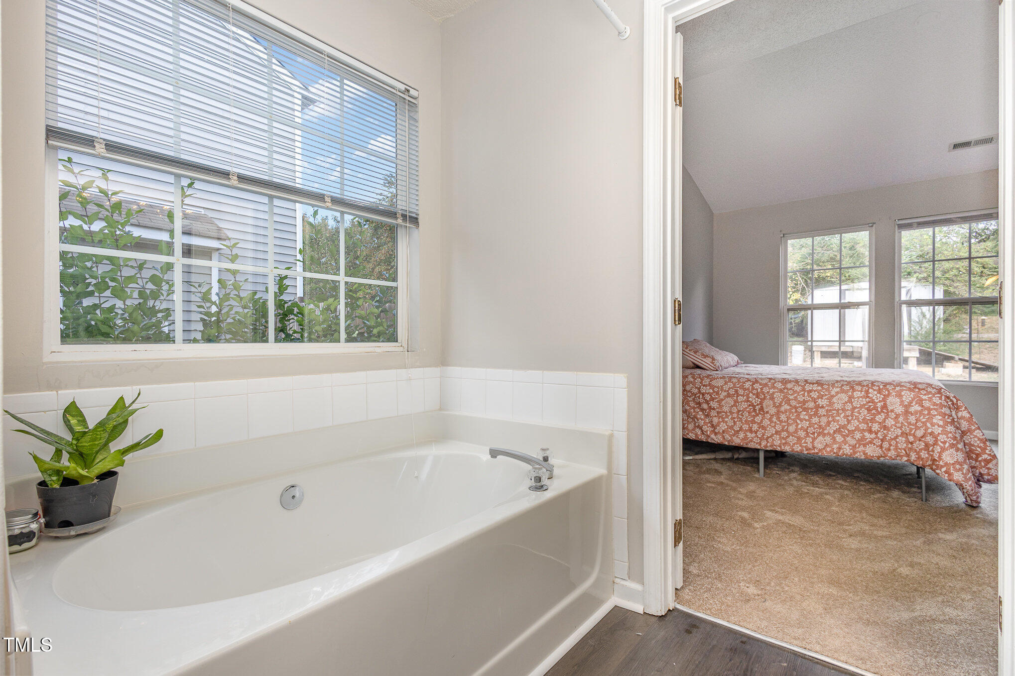 4331 Crowfield Drive Raleigh, NC 27610 - Photo 18 of 26 a bathroom with a bathtub and window
