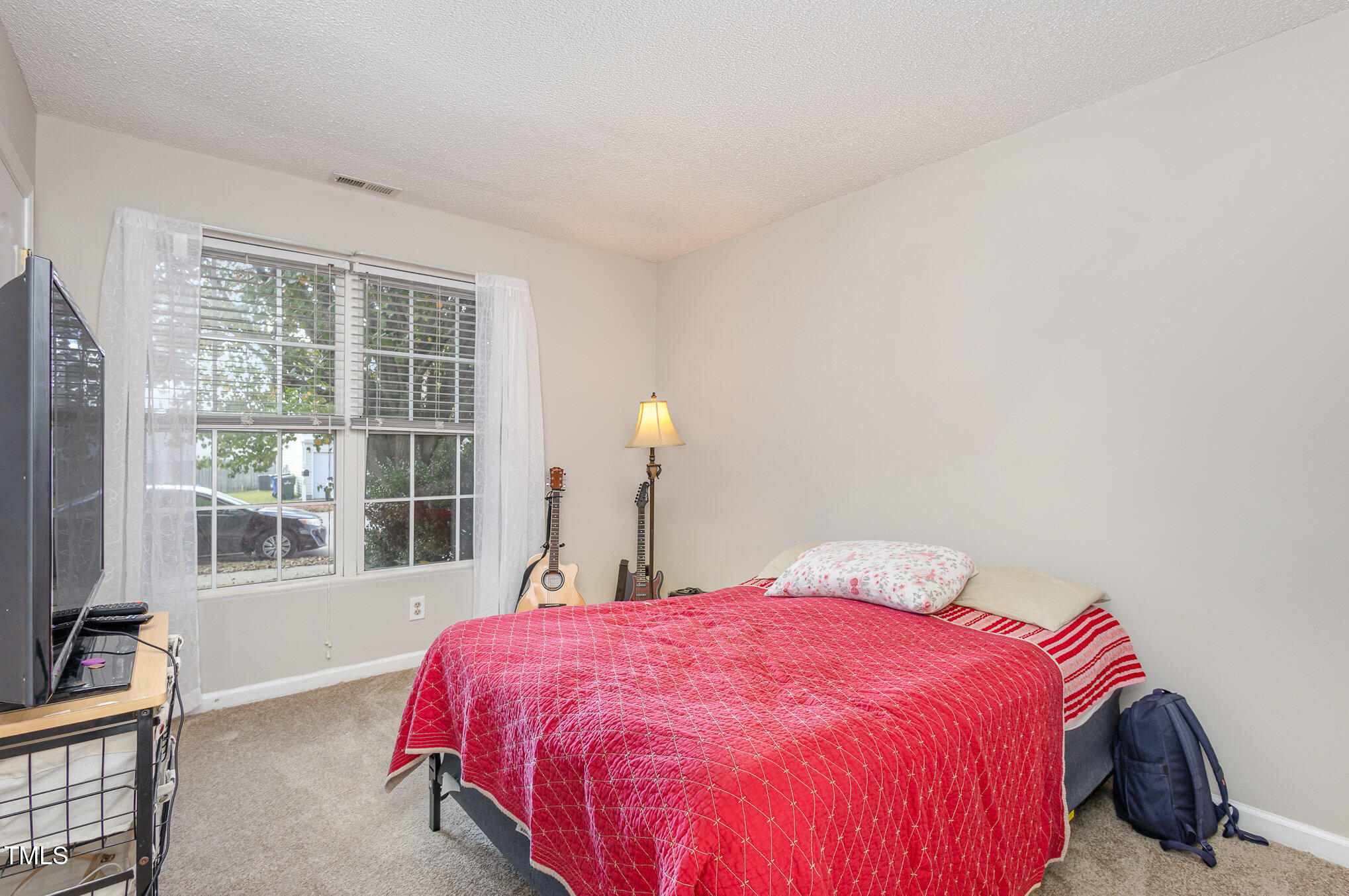 4331 Crowfield Drive Raleigh, NC 27610 - Photo 19 of 26 a bed sitting in a bedroom next to a window
