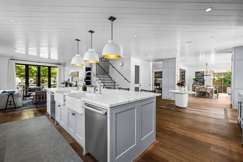 a kitchen with a stove and a wooden floor