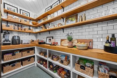 a kitchen with stainless steel appliances lots of white cabinets