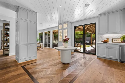 a view of a kitchen with furniture and floor to ceiling window