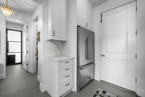 a view of a kitchen with refrigerator and cabinet