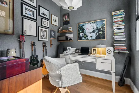 a living room with furniture and a kitchen view