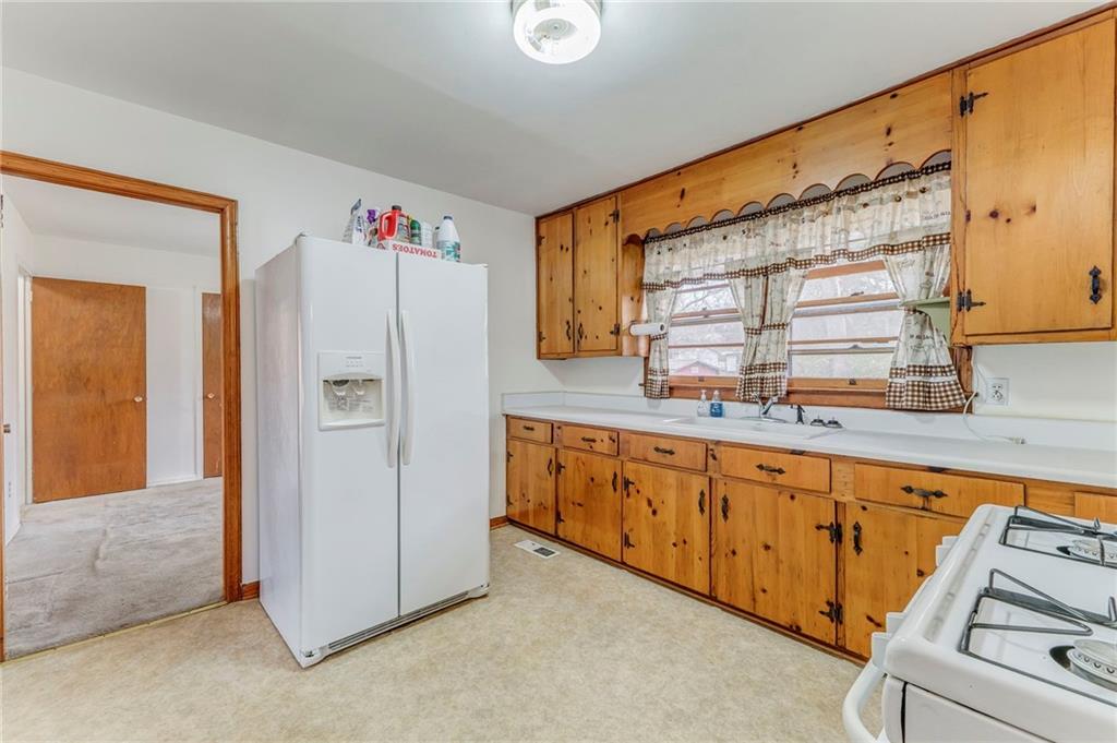 6 Don Drive Northeast Rome, GA 30165 - Photo 22 of 42 a kitchen with granite countertop white cabinets and refrigerator