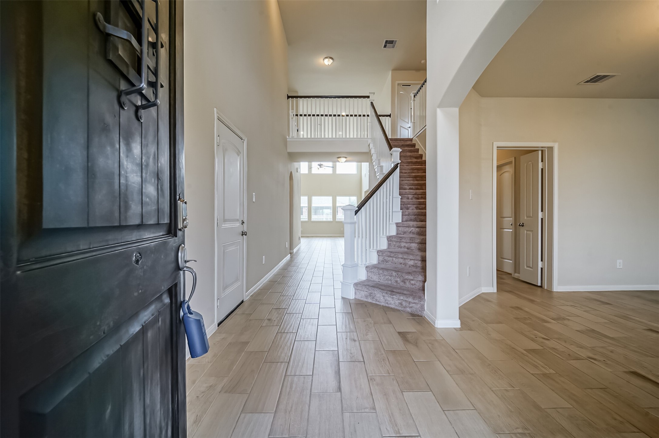 10003 Open Slope Court Humble, TX 77396 - Photo 18 of 25 Formal entry with wood look tile floors and tall ceilings.